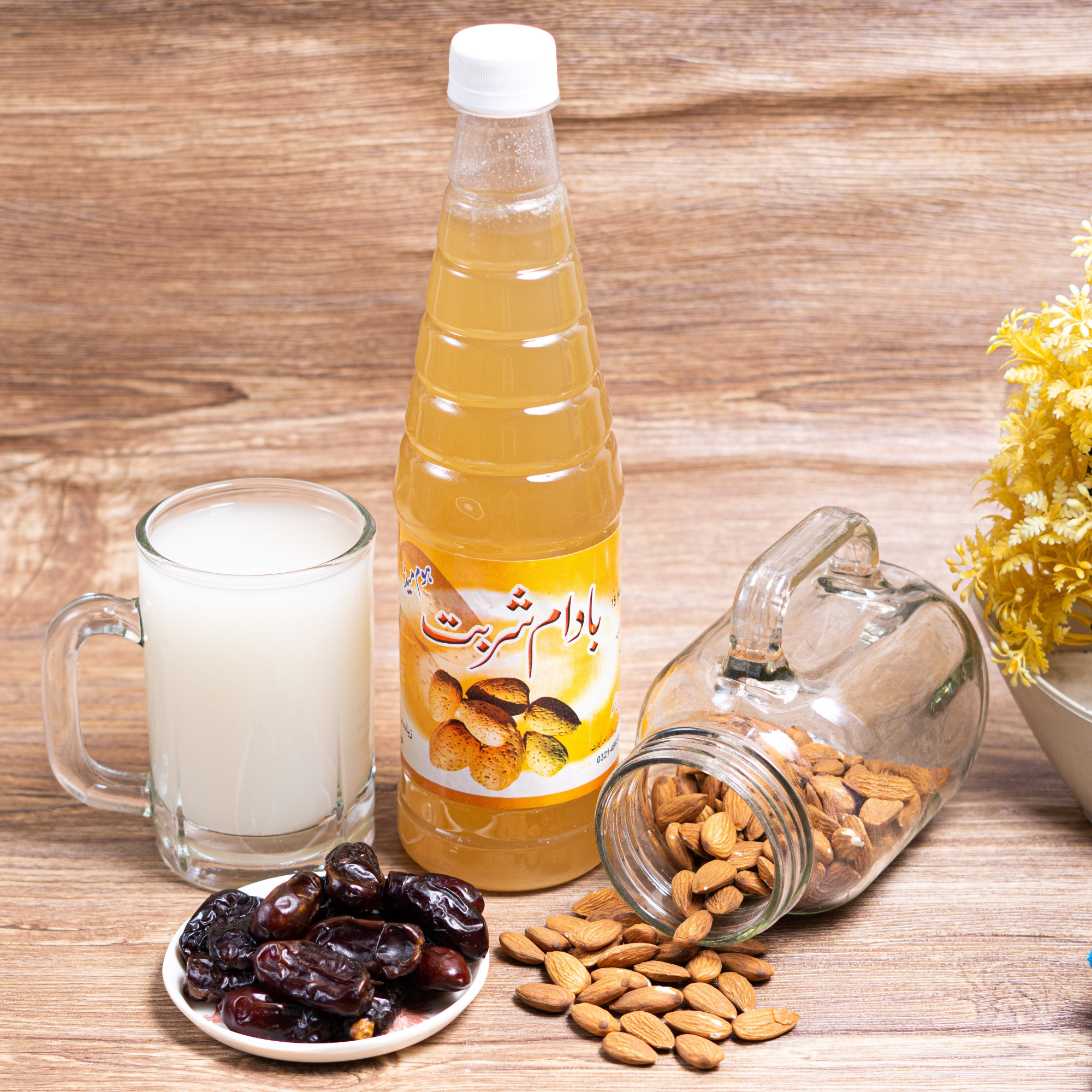 Badam Sharbat Bottle and ready to drink sharbat glass with almonds and dates.